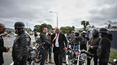 Members of a biker gang are welcomed by a mourner and Omar Nabi (left) as they attend the funeral of Mr Nabi’s father Haji Mohammed Daoud Nabi, 71. AFP