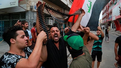 Protesters hold bullets belonging to Iraqi police during a protest in Baghdad. The Iraqi security forces clashed with anti-government protesters in the capital and other provinces Tuesday, killing and injuring civilians, according to officials. AP