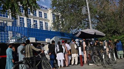 Afghans in a queue to withdraw cash in Kabul. The Taliban appointed an acting central bank chief after the former governor left Afghanistan as the militants seized power. AFP