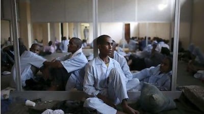 Pro-Qaddafi soldiers rest in a school converted into a prison in Tripoli, Libya.
