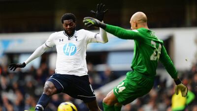 Emmanuel Adebayor, left, of Tottenham Hotspur puts Tim Howard, the Everton goalkeeper, under pressure during the Premier League match on Sunday. Shaun Botterill/Getty Images