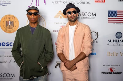 US singer Pharrell Williams and French artist and photographer JR attend the Forever Is Now exhibition in October, 2021. AFP