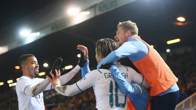 Grealish celebrates with teammates Gabriel Jesus and Kevin De Bruyne. Getty