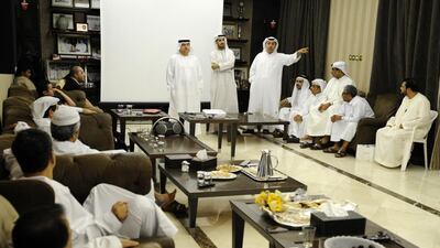 Ahmed Ahli, standing right, joined by his brother Ibrahim, left, at his majlis in September 2011 in Dubai. Charles Crowell for The National