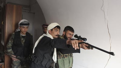 Free Syrian Army fighters aim a weapon from inside a room in Bab Antakya district in Old Aleppo. Molhem Barakat / Reuters