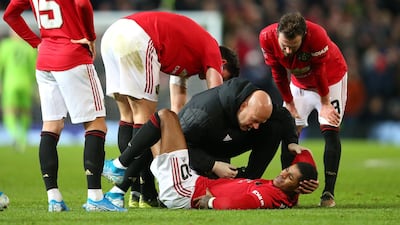 Marcus Rashford of Manchester United gets treatment after his injury at Old Trafford. Getty