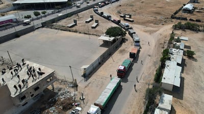 A convoy of lorries carrying humanitarian aid enter the Gaza Strip from Egypt via the Rafah border crossing on October 21, 2023. AFP