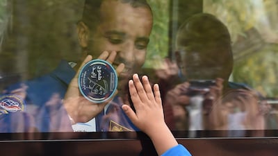 Hazza Al Mansouri waves from inside a bus during a farewell ceremony outside the Cosmonauts' hotel on his way to the Russian-leased Baikonur cosmodrome in Kazakhstan on September 25, 2019. Vyacheslav Oseledko / AFP