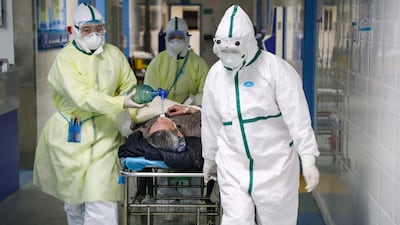 Medical workers in protective suits move a patient at an isolated ward of a hospital in Caidian district following an outbreak of the novel coronavirus in Wuhan, Hubei province, China. REUTERS