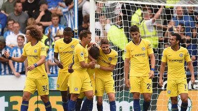 Chelsea's French midfielder N'Golo Kante, centre, celebrates with teammates after scoring the team's first goal. AFP