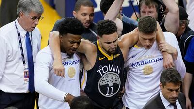 Golden State Warriors guard Klay Thompson is helped off the court after being fouled by Toronto Raptors guard Danny Green. EPA