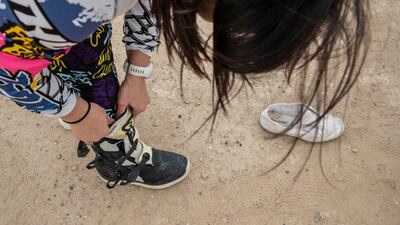 Christie tightens up her boots before heading out into the sand dunes