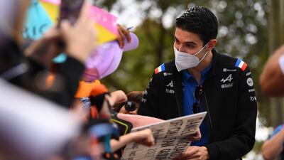 Alpine driver Esteban Ocon arrives at the Albert Park Grand Prix Circuit and signs autographs. EPA