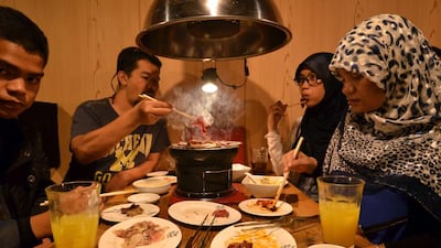 Thai Muslim tourists enjoying Halal certified foods at a barbecue restaurant in Tokyo. Prayer rooms, hijabs made from local silk and even Halal-certified whale meat are appearing in Japan as tourism bosses wake up to the demand from Muslim travellers. AFP PHOTO / Yoshikazu TSUNO