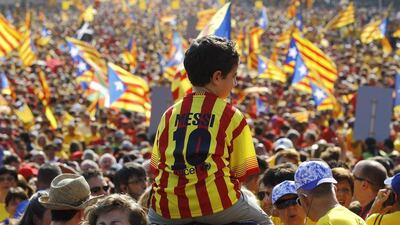 A young Barcelona fan wearing Lionel Messi's shirt shown last year at celebrates for Catalonia National Day at the Gran Via de les Corts Catalanes in Barcelona. Quique Garcia / AFP / September 11, 2014