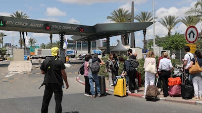 Travellers wait outside Israel's Ben Gurion airport for news on flights after the country activated air defences against a missile launched from Yemen that hit the airport on May 4. AFP