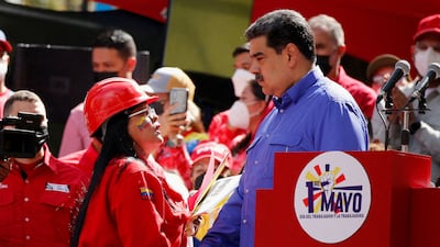 Venezuela's President Nicolas Maduro shakes hands with a state oil company PDVSA worker during May Day celebrations in Caracas. Reuters