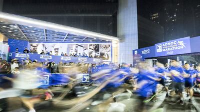 Participants starting the race at the Adnoc Abu Dhabi Marathon. Leslie Pableo for The National