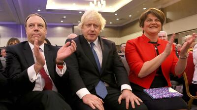 Boris Johnson (centre) is pictured with the DUP's Nigel Dodds (left) and Arlene Foster (right) in 2018. AFP