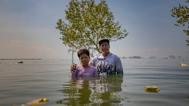 William Gregorio and his son Yamry on the spot where their ancestral home used to stand. Getty Images