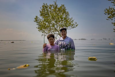 William Gregorio and his son Yamry on the spot where their ancestral home used to stand. Getty Images