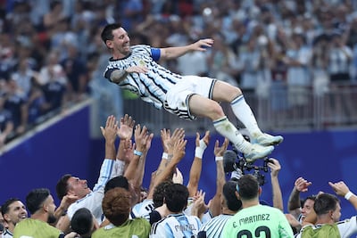 Argentina players throw Lionel Messi in the air to celebrate their World Cup win over Egypt. AFP