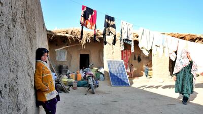 An Afghan girl leans against the wall of the mud house shared by three families who fled fighting between the Taliban and the government in Kandahar province. The house is in the province’s Zhari district, January 2021. Charlie Faulkner for The National