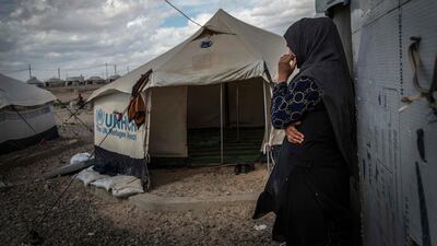 This photo released by Amnesty International shows 33-year-old mother of six, Zahra, outside a tent used for cooking inside in Salamiya camp for internally displaced people where she and her family have lived for 7 months. Claire Thomas / AP