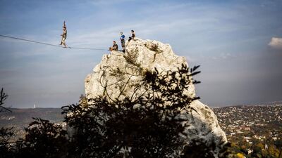 A man balances on a stretched belt during a slackline event organised by the Outdoor Inhales group at the Tunderszikla rock in Budapest, Hungary. Balazs Mohai/AP
