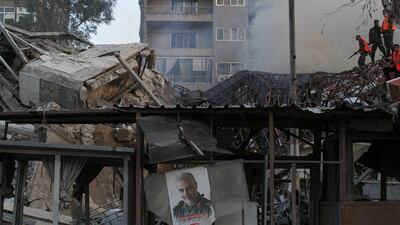 A picture of late Iranian military commander Qassem Suleimani hangs at the scene of Monday's Israeli air strike on Iran's embassy in Damascus. Reuters