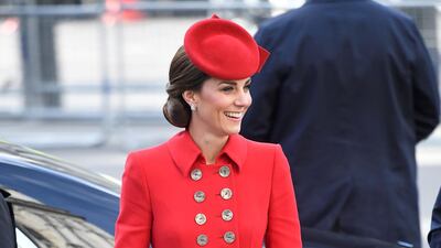 The Duchess of Cambridge wears buttoned red coat by Catherine Walker for the Commonwealth Service at Westminster Abbey on March 11, topped off with a suede clutch and pumps by Emmy London. The Duchess previously wore the look to New Zealand. Reuters