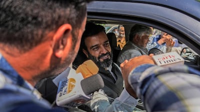 Jammu & Kashmir National Conference candidate Aga Syed Ruhullah Mehdi greets supporters outside a vote counting centre in Srinagar, Indian controlled Kashmir. AP