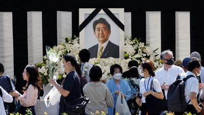 An altar was set up with Abe's picture outside the funeral venue. Reuters