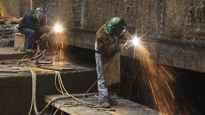 Workers from the Panama Canal Authority weld a gate at the bottom of the Miraflores floodgate during routine maintenance. The canal greatly reducing travel time between the Atlantic and the Pacific by eliminating the need for ships to go around the tip of South America. The construction claimed the lives of an estimated 30,000 workers, many from diseases like malaria and yellow fever. Arnulfo Franco / AP Photo