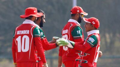 Oman celebrate the fall of a wicket during the World Cup League Two match against Nepal. Subas Humagain for The National