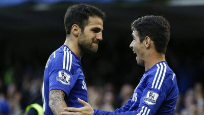 Oscar, right, celebrates with Cesc Fabregas, left, after scoring a goal for Chelsea in their Premier League win over QPR on Saturday. Kirsty Wigglesworth / AP/ November 1, 2014