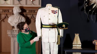 A curator adjusts a display of items at the exhibition at Windsor Castle. Getty Images