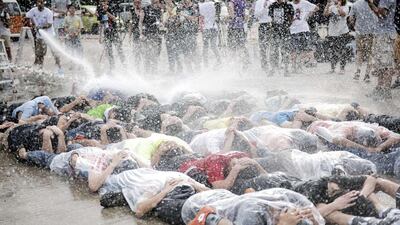 Democracy activists are hit with a water cannon during a "resistance workshop" earlier this month, which they said was in preparation for Occupy Central activities in Hong Kong. Alex Ogle / AFP