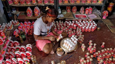 A woman paints idols of Hindu god Ganesh, the deity of prosperity, and goddess of wealth Laxmi, which will be worshipped during Diwali, the Hindu festival of lights, at a workshop in Kolkata, India October 18, 2019. Reuters