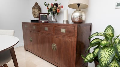 A buffet near the dining table, which was custom-made for its previous owner by a famous woodworker in China