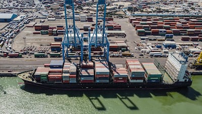 An aerial view of containers being unloaded from a cargo ship moored at the port of Umm Qasr, south of Iraq's southern city of Basra.