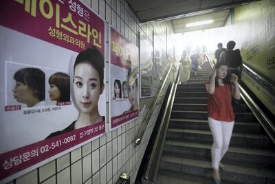 Posters inside a subway station in Seoul advertise plastic surgery. Bloomberg