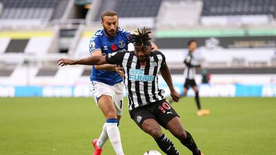 Newcastle's Allan Saint-Maximin under pressure from Cenk Tosun of Everton. Getty