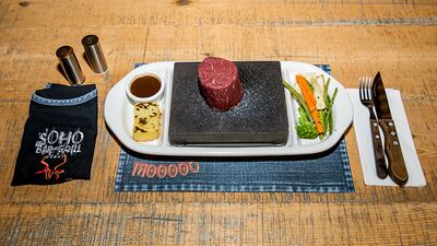 Steak cooking on the SoHo Stone. Courtesy SoHo Bar & Grill