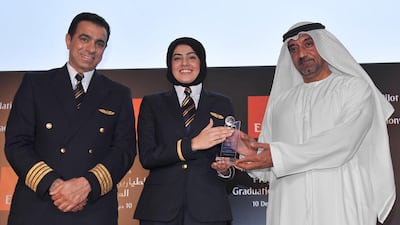 Sheikh Ahmed Bin Saeed Al Maktoum, the chief executive of Emirates, and Captain Nabil Al Boom, the deputy manager for the national cadet pilot programme, present certificates of completion to the graduates of the airline’s training academy. Courtesy Emirates