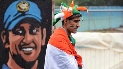 The wait was starting to get frustrating even to the most hopeful of fans, such as this man standing by a painting of MS Dhoni, the India captain, as the prospect of a washout became imminent. Philip Brown / Reuters