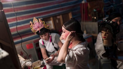 Performers apply their make up before heading out on stage. EPA