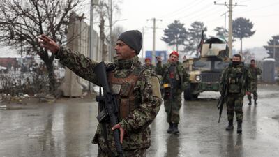 Afghan national army soldiers stand guard at the entrance gate of the Marshal Fahim military academy in Kabul, Afghanistan. Rahmat Gul / AP