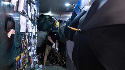 Protesters smash the glass entrance to the office of Mr. Ho in Hong Kong's Tsuen Wan district. AFP