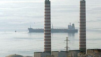 A tanker carrying fuel oil passes by the oil refinery near Zouk, Lebanon. EPA / WAEL HAMZEH